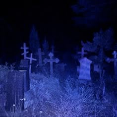 a cemetery with graves in the dark at night