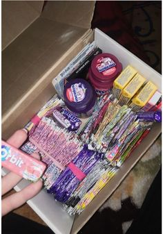 someone is holding their hand over the contents of a box