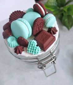 there are many cookies and chocolates in the glass jar