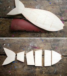 two wooden fish cutouts sitting on top of a piece of wood next to each other