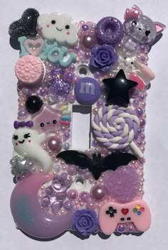 the letter e is made up of many different types of buttons and beads, including cats