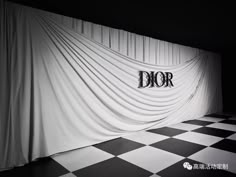 a black and white photo with the word dior on it's curtained wall