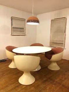 an oval dining table with four chairs around it