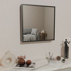 there is a mirror on the wall above a table