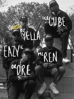 four young men sitting on top of a brick wall with words written across the faces