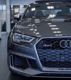 the front end of an audi car in a showroom
