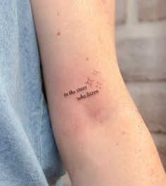 a person with a tattoo on their arm that says to the stars who listen