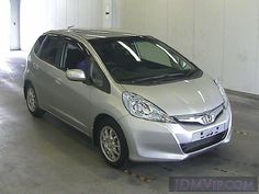 a small silver car parked in a garage