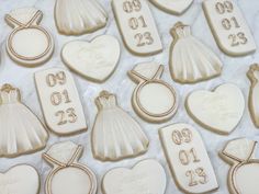 wedding cookies are arranged in the shape of bride and groom's dresses, rings, and gowns