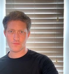 a man is taking a selfie in front of the window