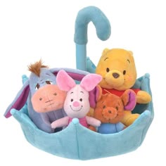 winnie the pooh, piglet, eeo and friends in a basket with an umbrella