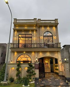 the front of a building with lights on