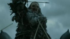 a woman in a fur coat holding two spears