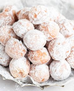 powdered sugar covered donuts in a bowl