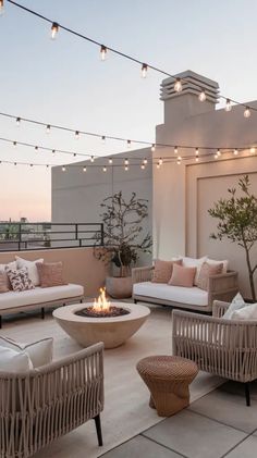 an outdoor patio with wicker furniture and string lights