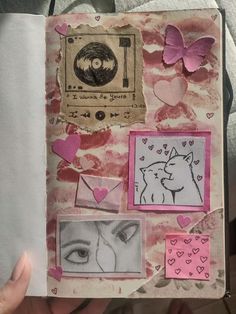 an open book with pictures and hearts on it