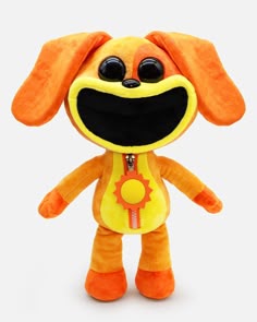 an orange stuffed animal with big eyes and a smile on it's face,