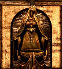 a golden statue in front of a stone wall with an arched doorway and gold accents