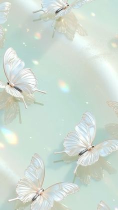 several white butterflies floating on top of a blue and green water filled with light bubbles