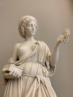 a statue of a woman holding something in her hand