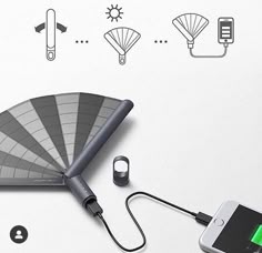 an electronic device with a fan attached to it's side and other accessories surrounding it