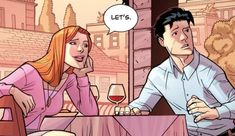 a man sitting at a table next to a woman with a glass of wine in her hand