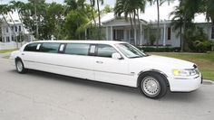 a white limousine parked in front of a house
