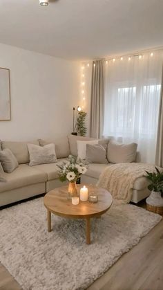 a living room filled with lots of furniture and candles on top of the coffee table