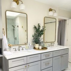 a bathroom with two sinks and mirrors in it