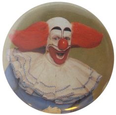 a clown with red hair wearing a white dress