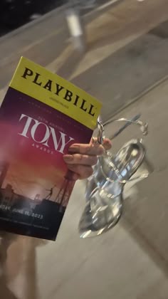 a person holding up a book in their hand