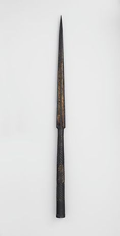 a black and gold pen sitting on top of a white surface