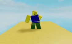 a lego man standing on top of a sandy hill