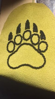 a yellow towel with a black dog paw on it