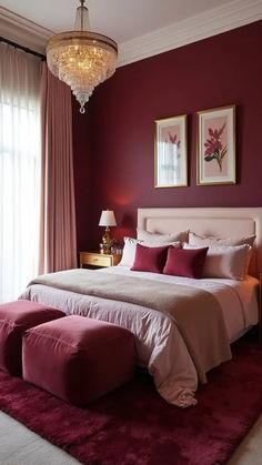 a bedroom with red walls and white bedding in the center, two framed pictures on the wall