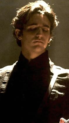 a young man is looking at his cell phone