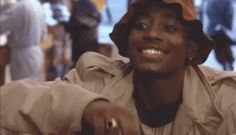 a woman wearing a hat sitting at a table