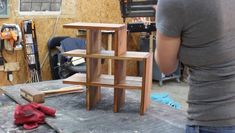 a woman standing in front of a wooden shelf