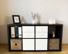 a black and white cabinet with baskets on top