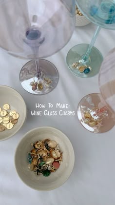 three wine glass charms sitting on top of a table next to some wine glasses with the words how to make wine glass charms