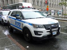 two police cars are parked on the side of the street