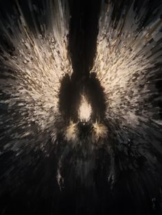 an abstract black and white photo with some light coming from the center in the middle