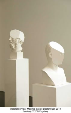 three white busturines sitting on pedestals in an art gallery, each with their own individual head