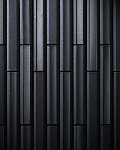 a black textured wall with vertical lines in the center and diagonals on each side
