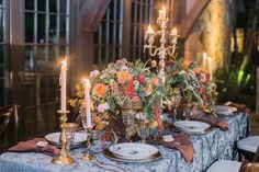 the table is set with candles and flowers