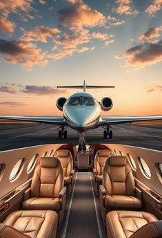 the inside of a private jet with an airplane in the background
