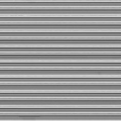 a black and white photo of the side of a building with vertical lines painted on it