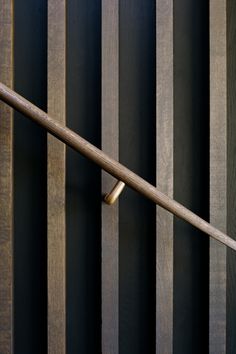 a close up of a wooden fence with a metal bar on the top and bottom