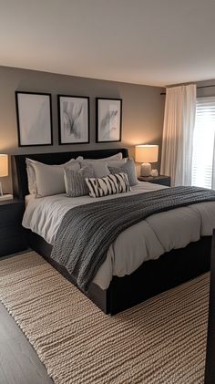 a large bed sitting in a bedroom next to two lamps on either side of it