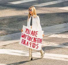 a woman holding a sign that says you are way too creative for a 10d5